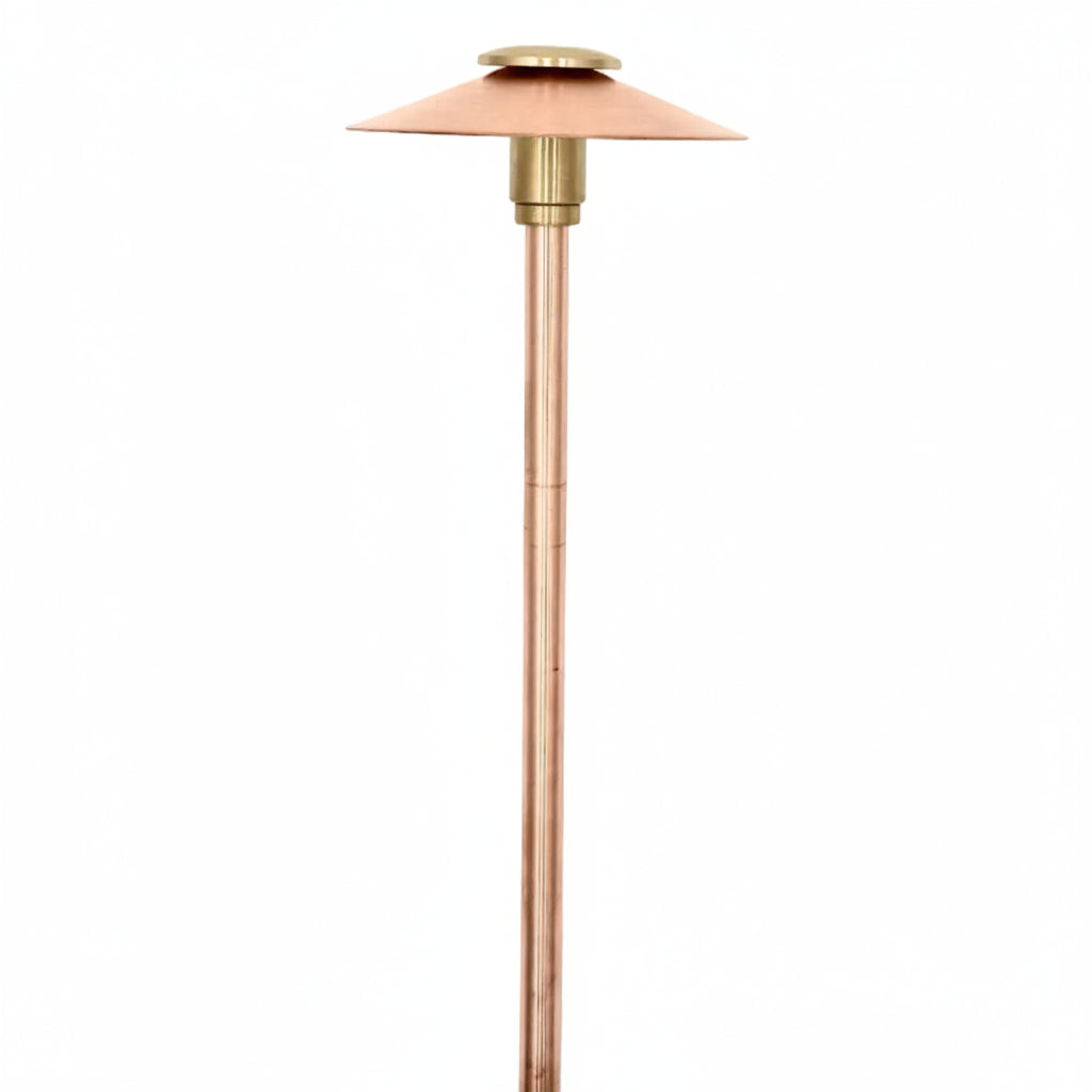 A modernist copper patio heater lamp with a conical shade, vertical copper tube, and black power cord, shown against a plain white background.