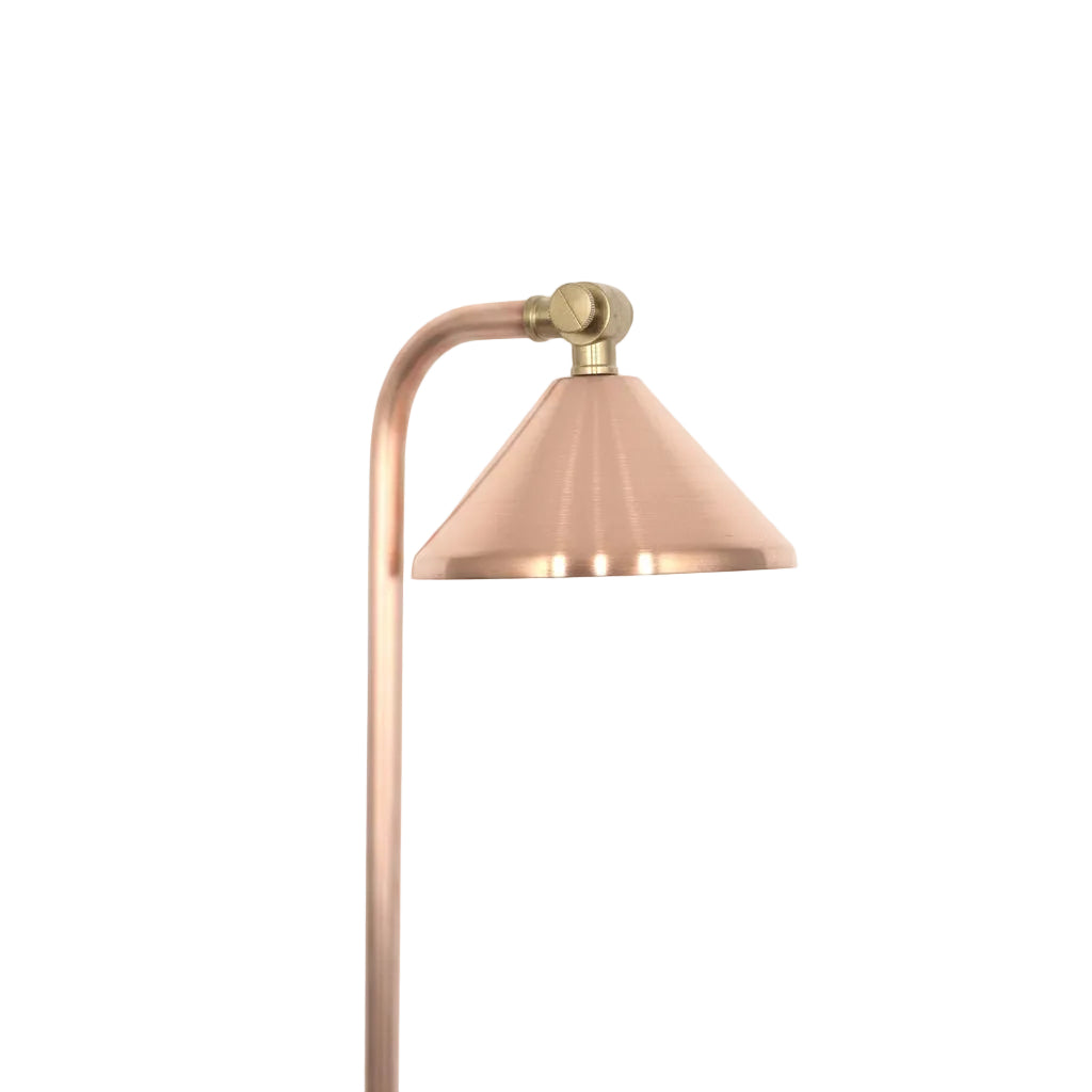A modern copper and brass floor lamp with a conical shade and curved arm, shown against a plain white background.
